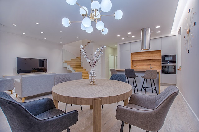 a large living dining room with a round table and t.v